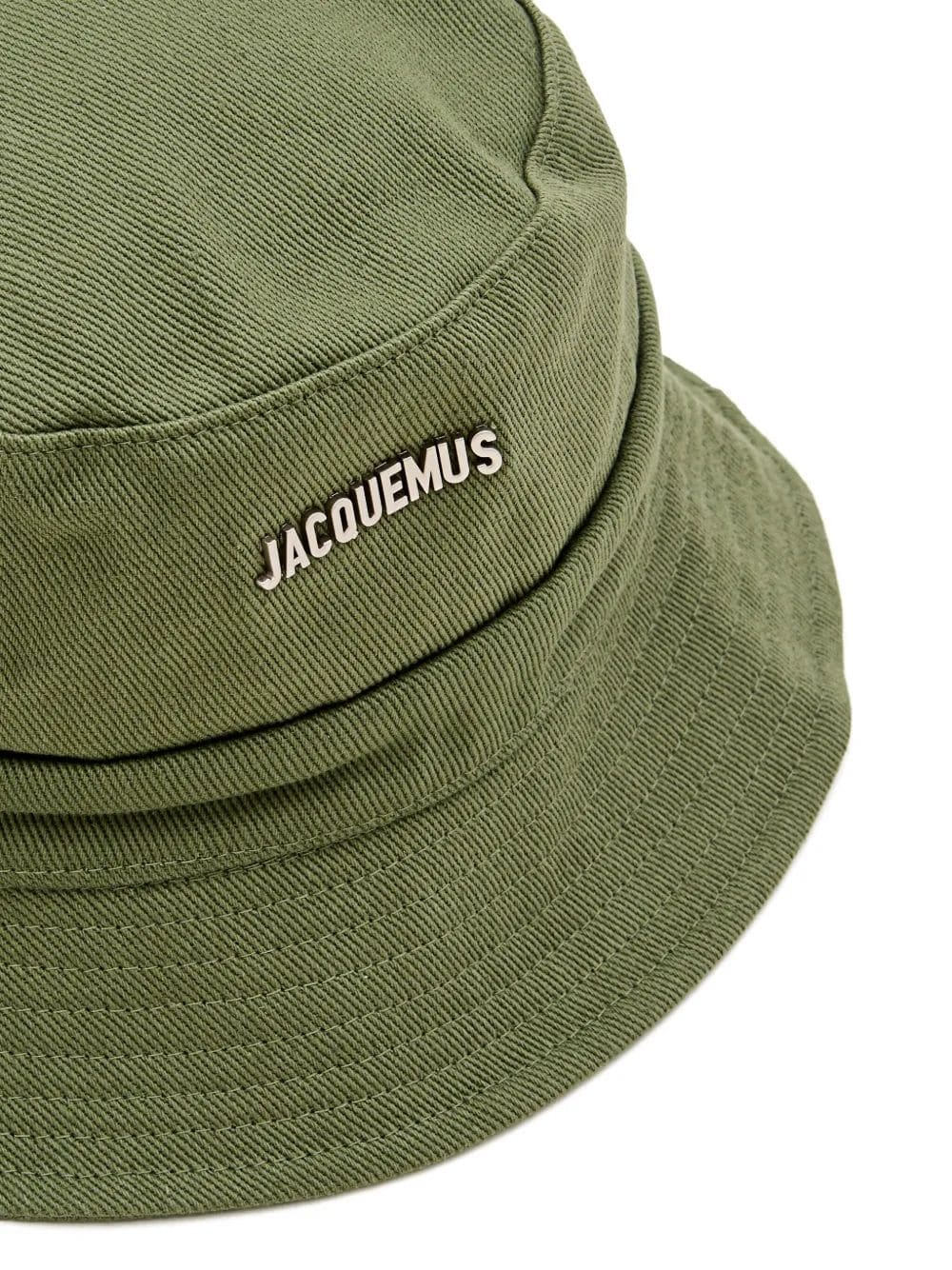 Olive green cotton bucket hat with 'JACQUEMUS' embroidered in white on the side, shown against a plain white background.