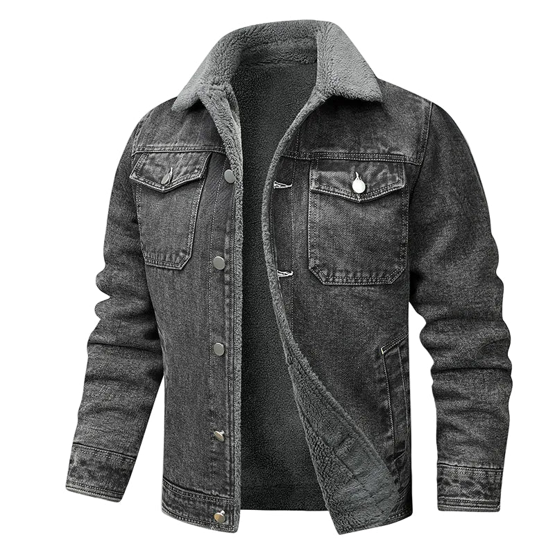 A dark gray washed denim jacket with a gray fleece collar, shown open over a dark gray shirt. A small flame graphic with the text 'WARM' appears in the top right corner.
