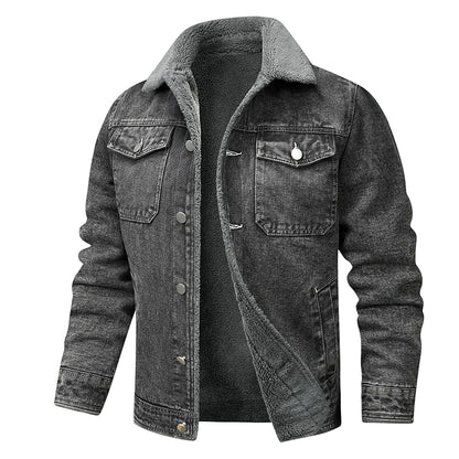 A dark gray washed denim jacket with a gray fleece collar, shown open over a dark gray shirt. A small flame graphic with the text 'WARM' appears in the top right corner.