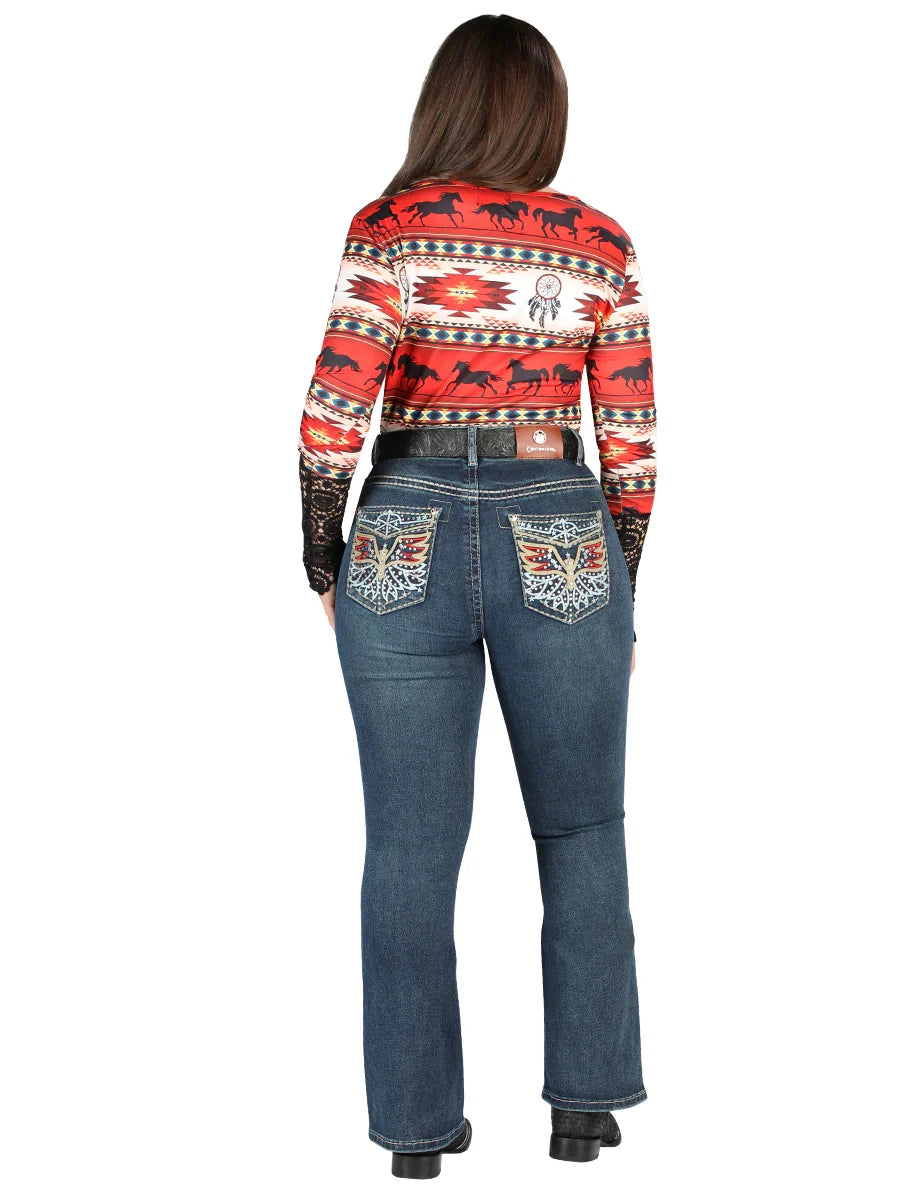 Person wearing a patterned sweater and blue jeans on a white background