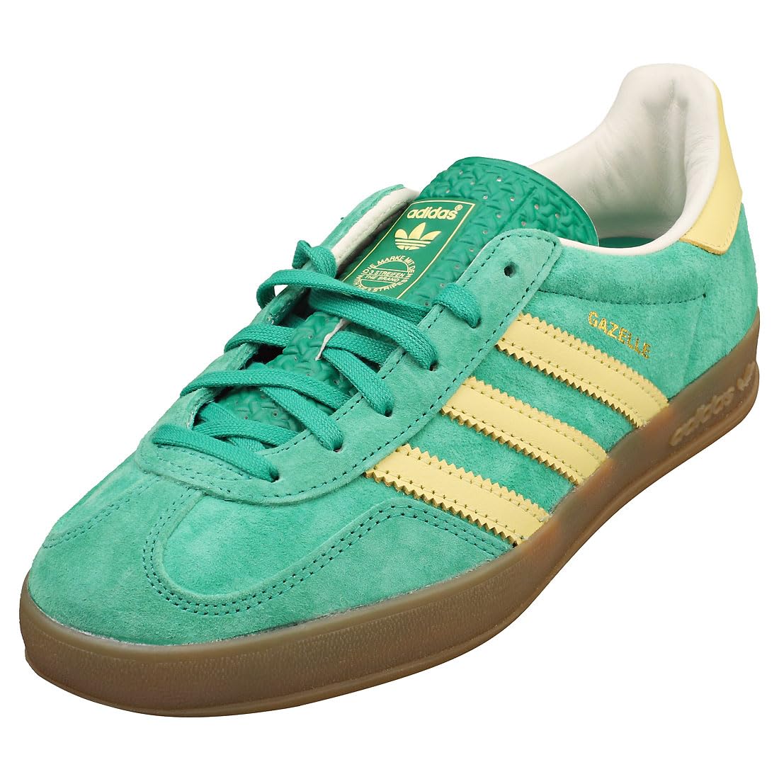 Green Adidas sneaker with yellow stripes on a white background