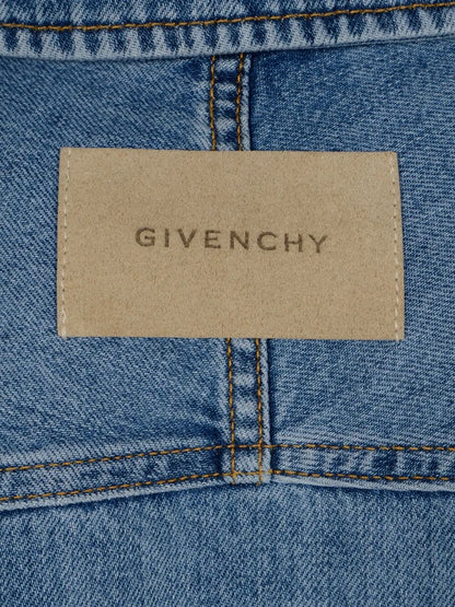 Close-up of a Givenchy label on a blue denim fabric.