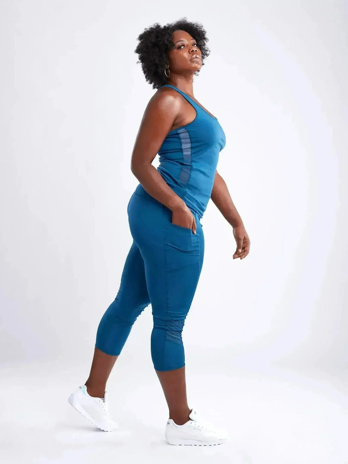 Woman wearing a blue athletic outfit on a white background