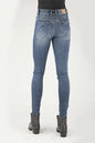 Blue jeans worn by a person on a white background