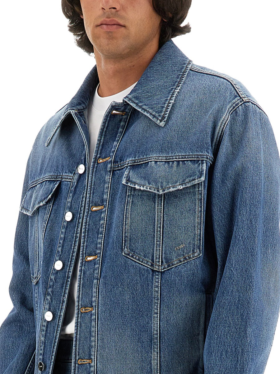 Blue denim jacket worn by a person on a white background