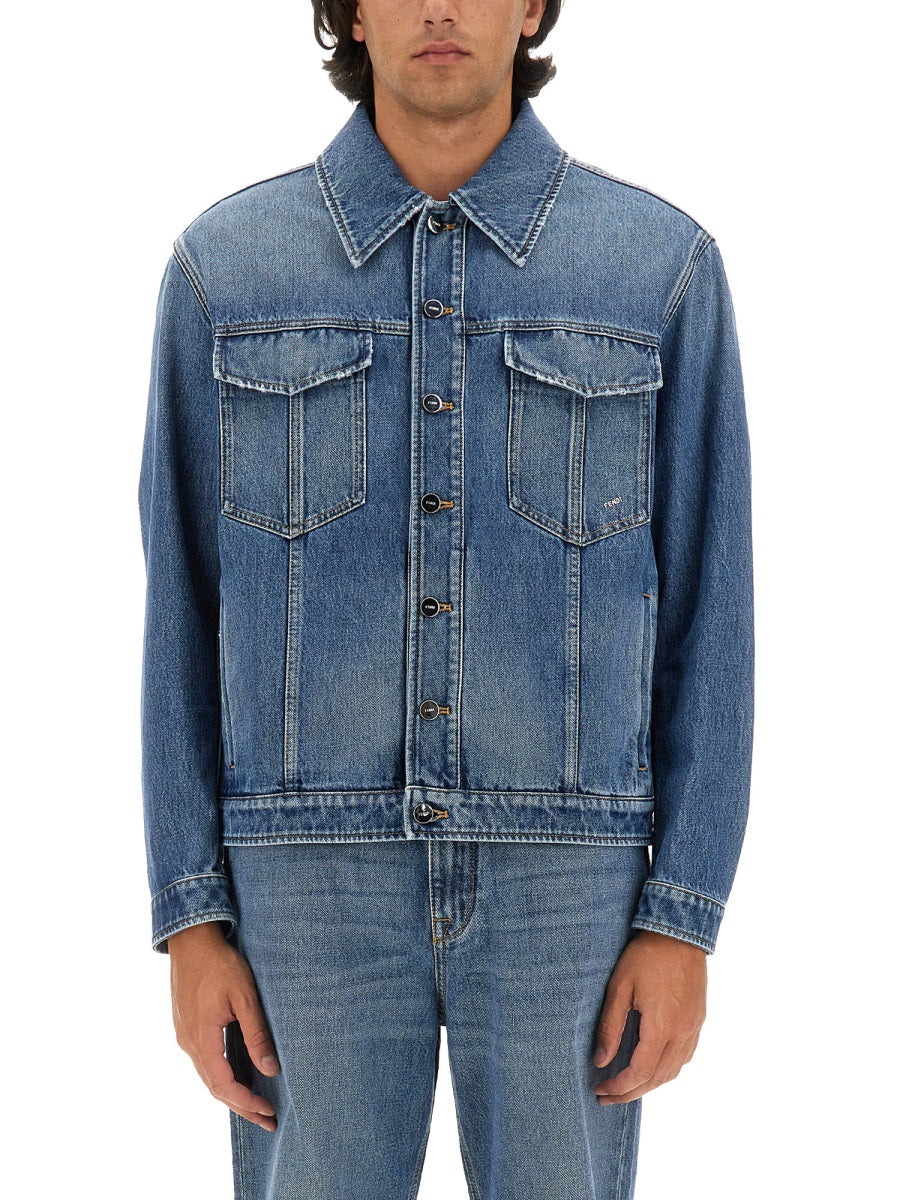 Man wearing a blue denim jacket and jeans on a white background