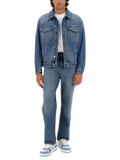 Person wearing a blue denim jacket and jeans on a white background