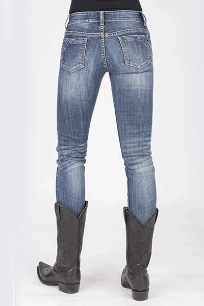 Blue jeans with gray boot tops worn by a person on a white background