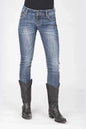Blue jeans worn by a person with black cowboy boots on a white background