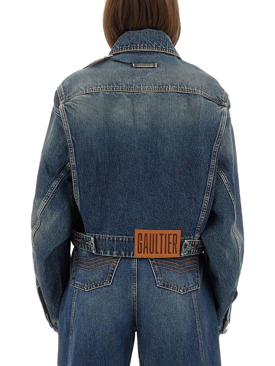 Blue denim jacket with a visible brand logo on a white background