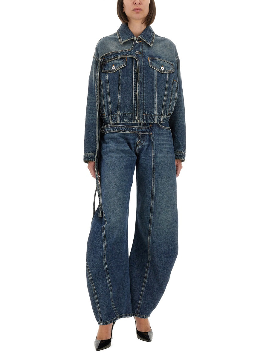 Person wearing a blue denim outfit on a white background