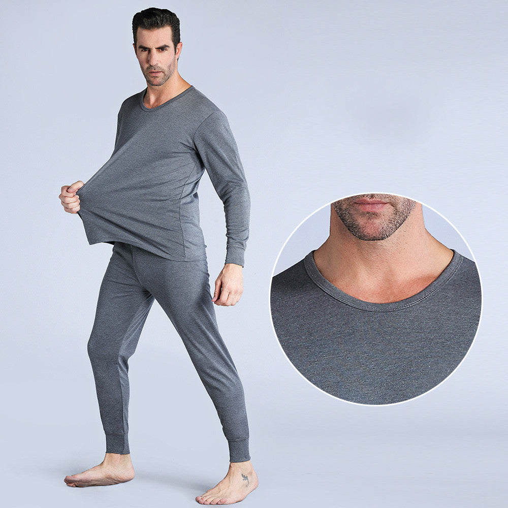 Man wearing gray thermal underwear with a close-up of the neckline on a light gray background