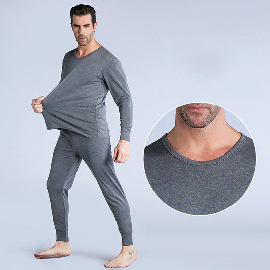 Man wearing gray thermal underwear with a close-up of the neckline on a light gray background