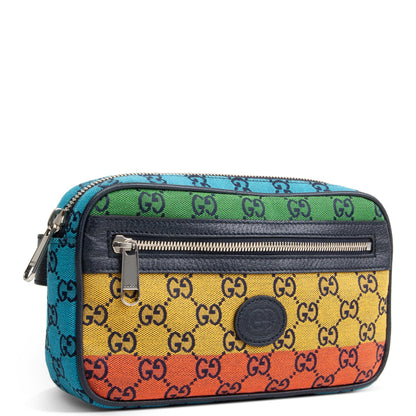 A Gucci cosmetic bag featuring a vibrant rainbow stripe design with the classic GG monogram pattern. The bag has horizontal stripes of turquoise blue, green, yellow, and orange, separated by dark navy leather zippers and trim.