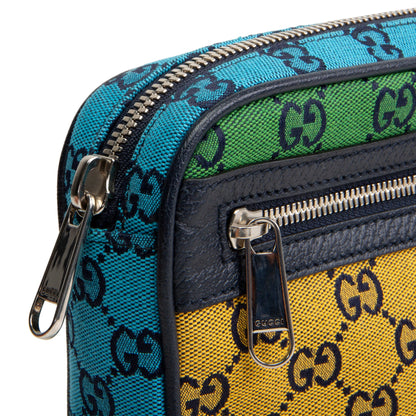Close-up of a Gucci crossbody bag showing the signature GG monogram canvas in turquoise blue, green, and yellow panels, with dark navy leather trim and silver-tone zippers.