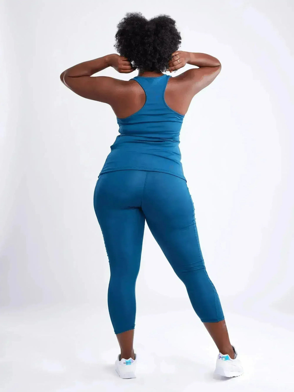 Person wearing a blue athletic outfit on a white background