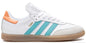 White sneaker with blue stripes and orange accents on a white background