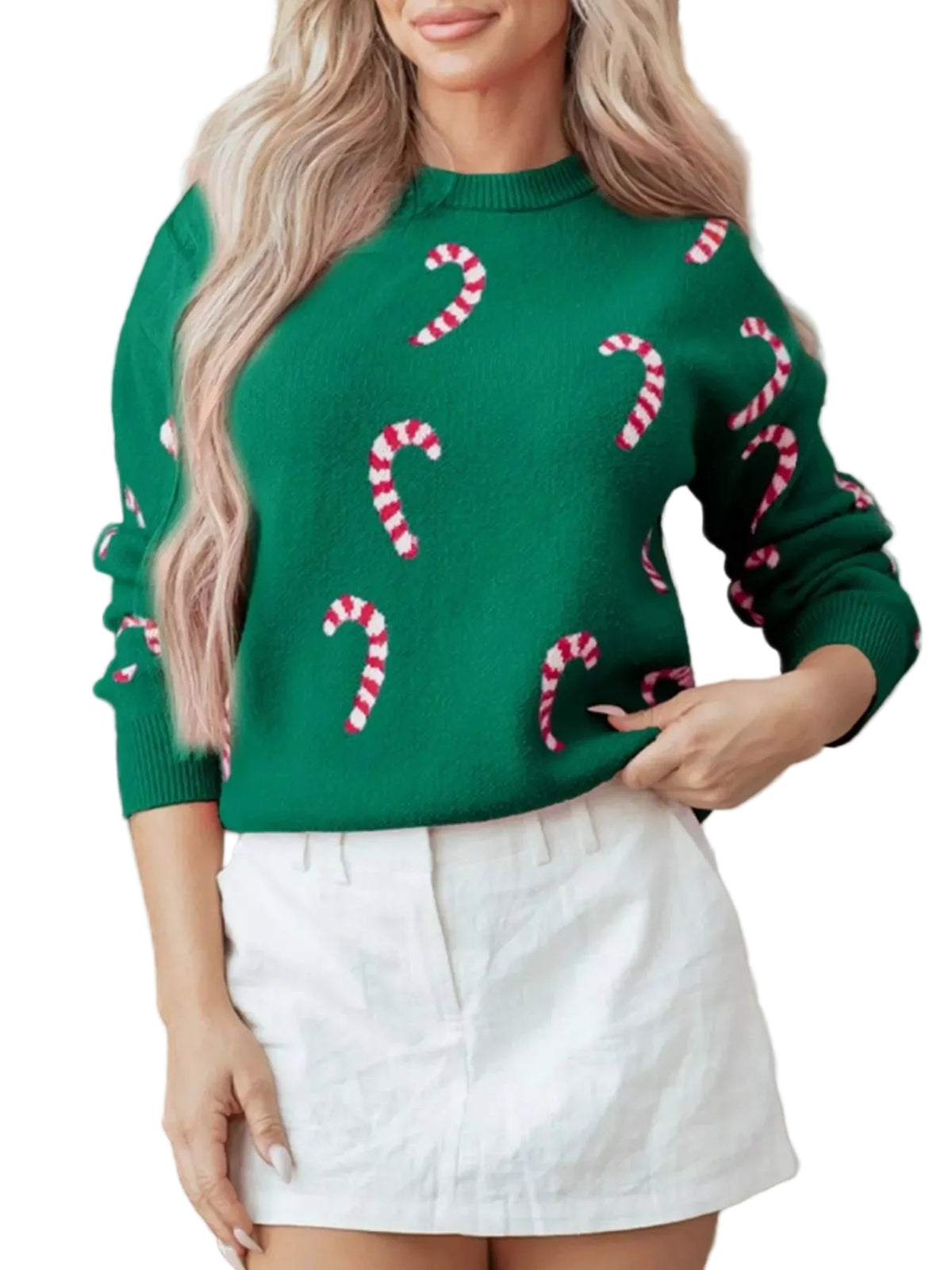 Person wearing a green sweater with candy cane patterns and a white skirt.