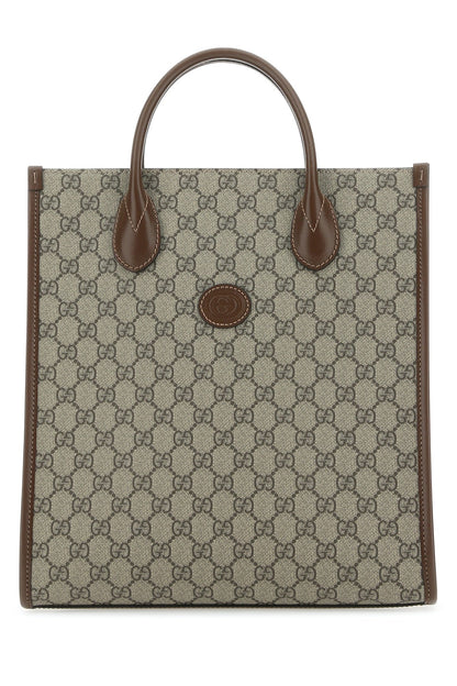 Tote bag with brown handle and patterned body on a white background