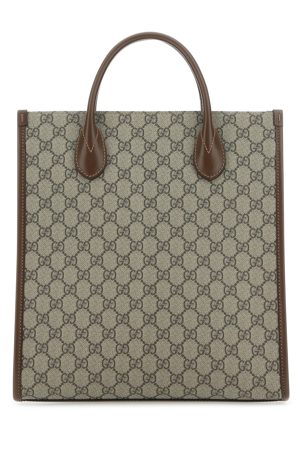 Designer tote bag with patterned fabric and brown leather handles on a white background