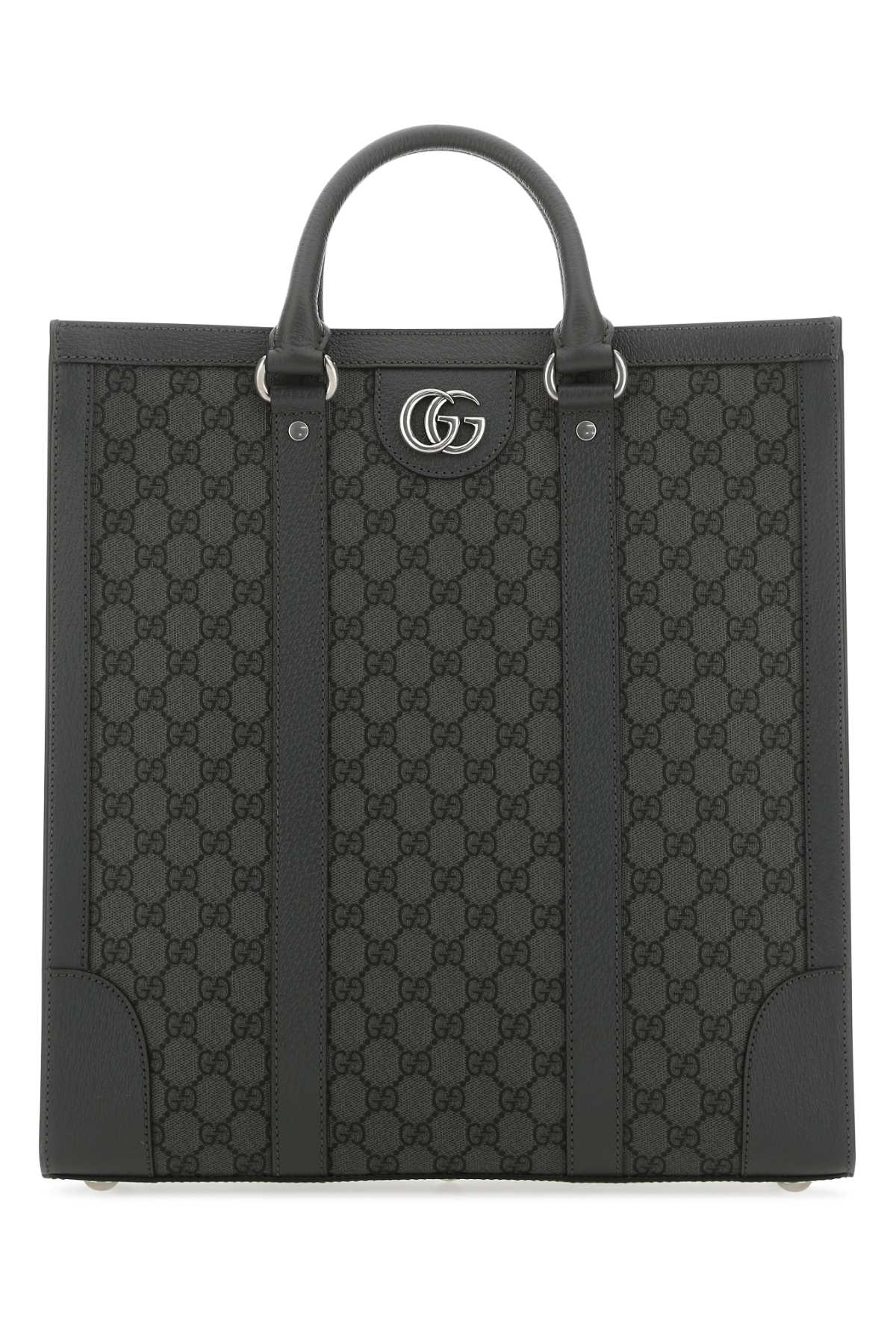 Black Gucci tote bag with iconic pattern on a white background