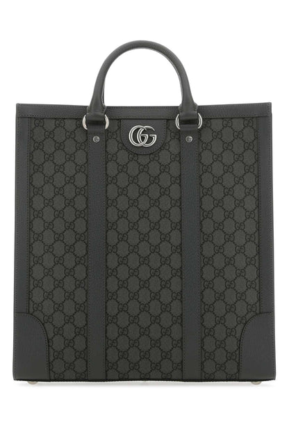 Black Gucci tote bag with iconic pattern on a white background