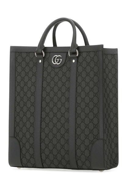 Black Gucci tote bag with iconic pattern on a white background