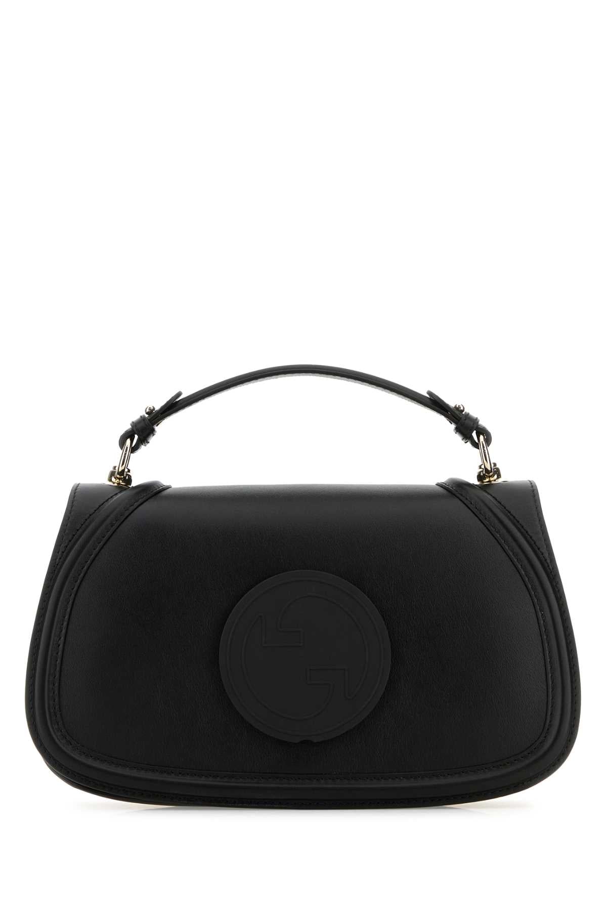 Black handbag with a circular design on a white background
