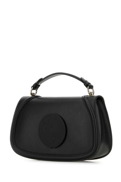 Black handbag with a circular design on a white background