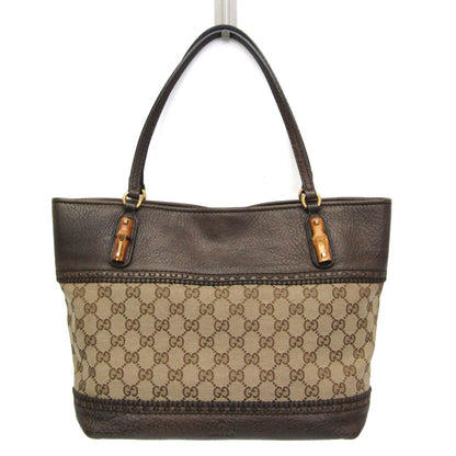 A Gucci tote bag featuring dark brown leather trim and handles, with a beige and brown GG Supreme canvas body, shown against a plain white background.