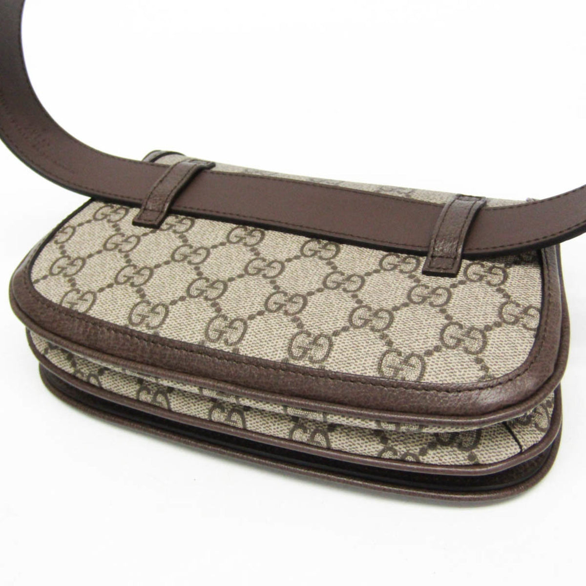 Designer handbag with brown leather strap on a white background