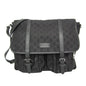 A black Gucci messenger bag featuring the brand's signature GG monogram canvas, black leather straps, and a front flap with a small metal Gucci logo plaque.