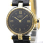 A vintage Cartier watch with a black dial, gold-tone case, and black leather strap, shown close-up against a white background.