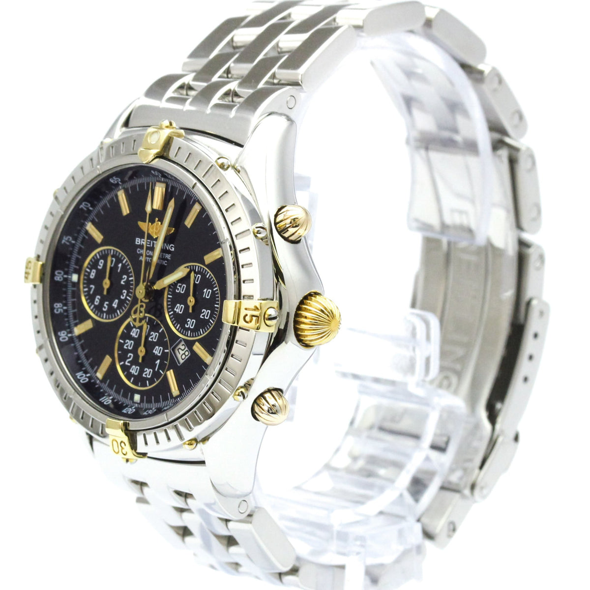 A Breitling wristwatch with a silver two-tone stainless steel bracelet, a black dial with gold accents, and a rotating bezel, shown on a clear plastic display stand against a white background.