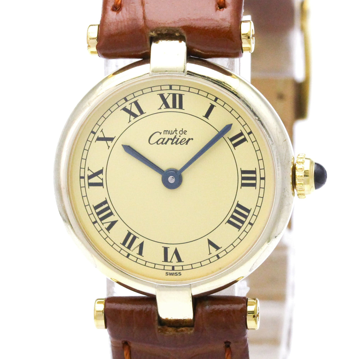 A Cartier watch with a round gold-tone case, cream-colored dial with black Roman numerals, blue hands, and a brown leather strap.