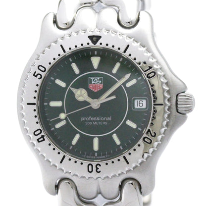 A silver stainless steel wristwatch with a dark green dial, featuring a rotating bezel, date window, and a silver link bracelet, shown against a plain white background.