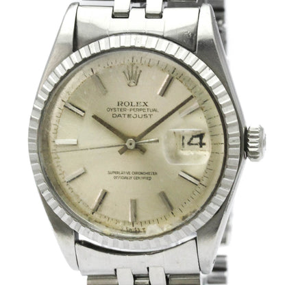 Silver Rolex watch with a beige dial on a white background
