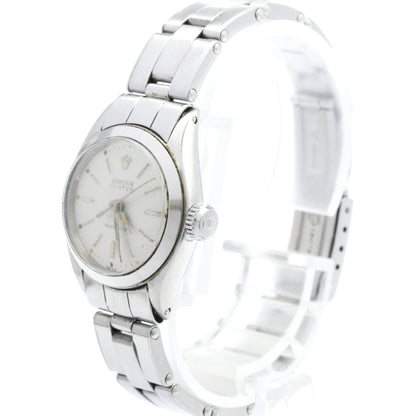 Silver wristwatch with a white face on a white background