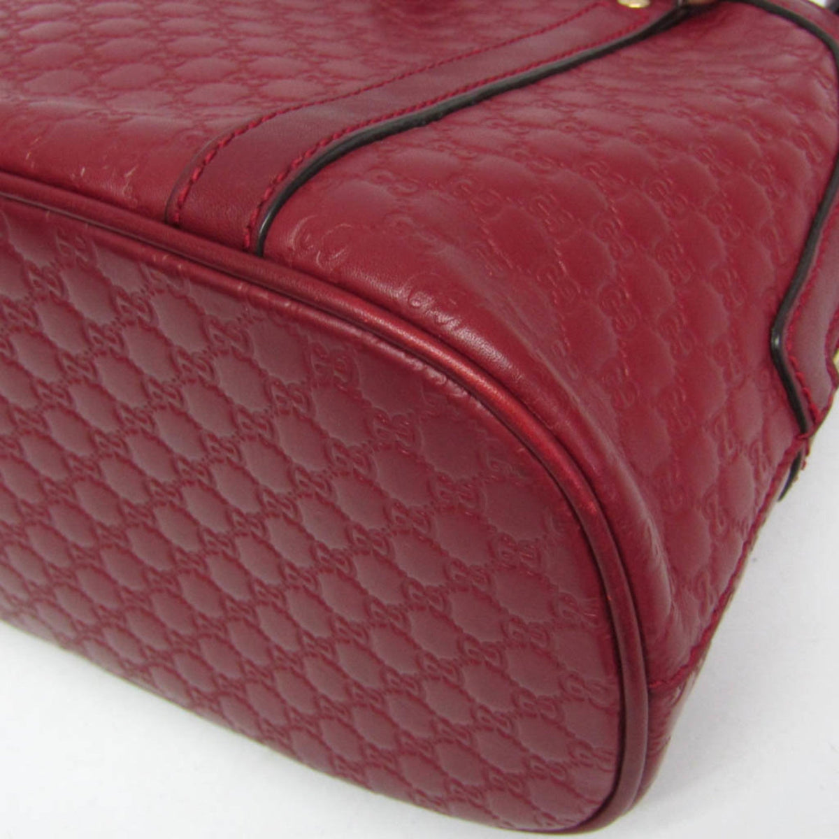 Close-up of a red quilted handbag on a white background