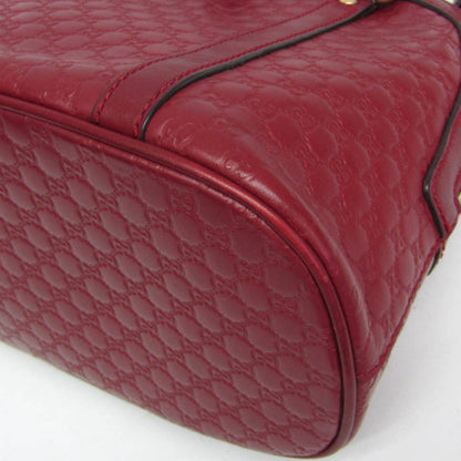 Close-up of a red quilted handbag on a white background