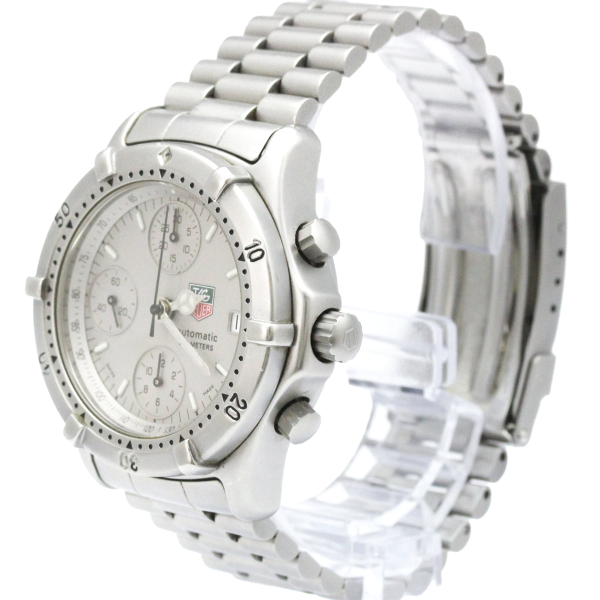 A silver stainless steel chronograph watch with a matching metal link bracelet, displayed on a clear plastic stand against a white background. The watch features a silver dial with three sub-dials and a rotating bezel.