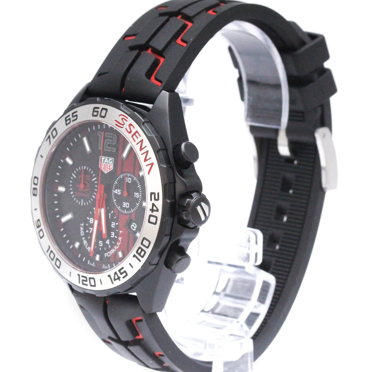 A TAG Heuer Senna chronograph watch with a black rubber strap featuring red stitching, a black dial with red accents, and a silver bezel with black markings.