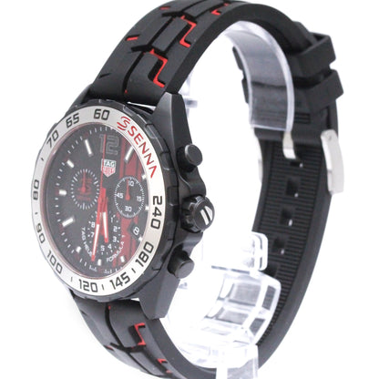 A TAG Heuer Senna chronograph watch with a black rubber strap featuring red stitching, a black dial with red accents, and a silver bezel with black markings.