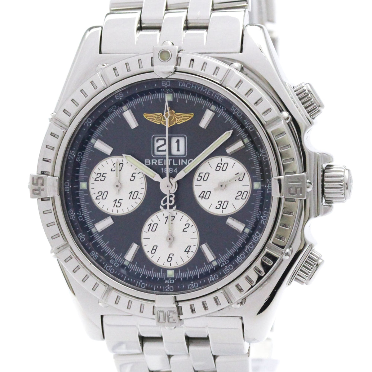 A Breitling wristwatch with a silver stainless steel case and bracelet, featuring a dark blue dial with white subdials and a silver tache time indicator.