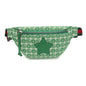 A green and white GG monogram canvas fanny pack with a green leather star patch on the front, a green zipper, and a red and green striped web stripe detail on the side, shown against a plain white background.