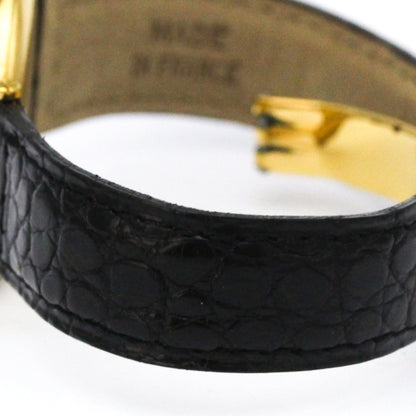 A close-up of a black textured leather cuff bracelet with a gold-toned metal clasp, showing the interior lining with 'MADE IN FRANCE' text.