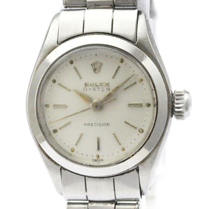 Silver Rolex watch with a white face on a white background