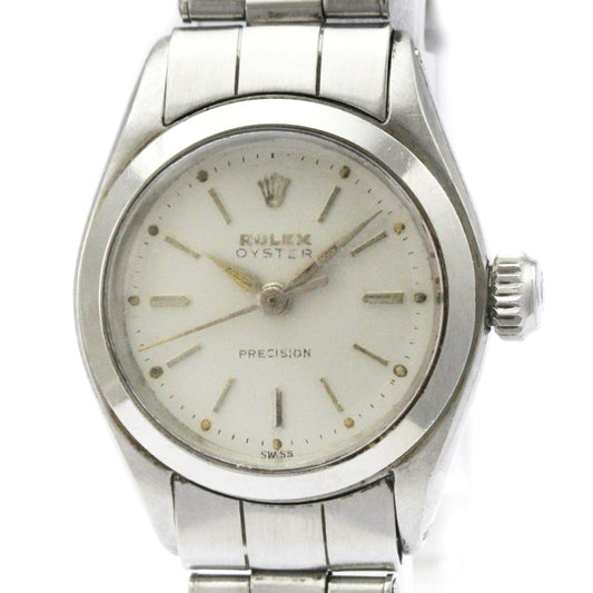 Silver Rolex watch with a white face on a white background