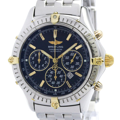 A Breitling Chrono Daytona Automatic watch with a silver stainless steel bracelet, a dark blue dial, and gold-tone accents, shown on a white background.
