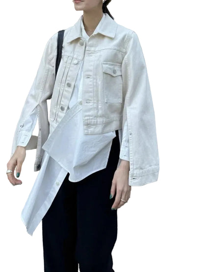 Person wearing a white denim jacket over a white shirt with black pants, standing outdoors.